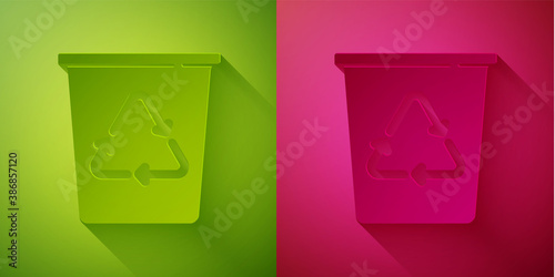 Paper cut Recycle bin with recycle symbol icon isolated on green and pink background. Trash can icon. Garbage bin sign. Recycle basket sign. Paper art style. Vector.