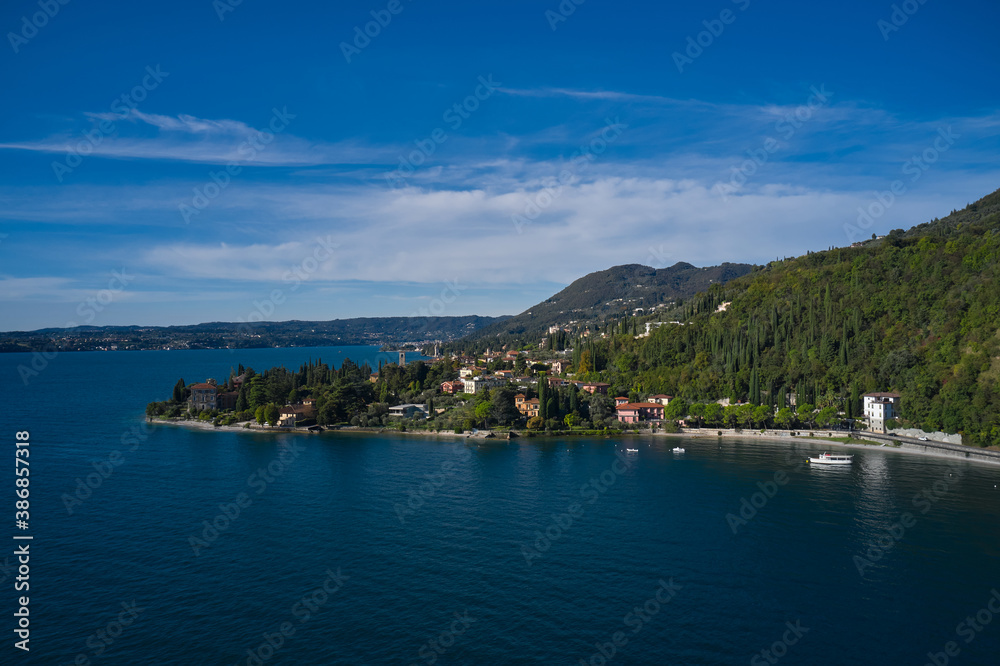 Aerial view of the town on Lake Garda. Tourist place on Lake Garda in the background Alps and blue sky. Panoramic view of the historic city of Toscolano Maderno on Lake Garda Italy.