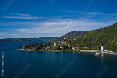 Aerial view of the town on Lake Garda. Tourist place on Lake Garda in the background Alps and blue sky. Panoramic view of the historic city of Toscolano Maderno on Lake Garda Italy.