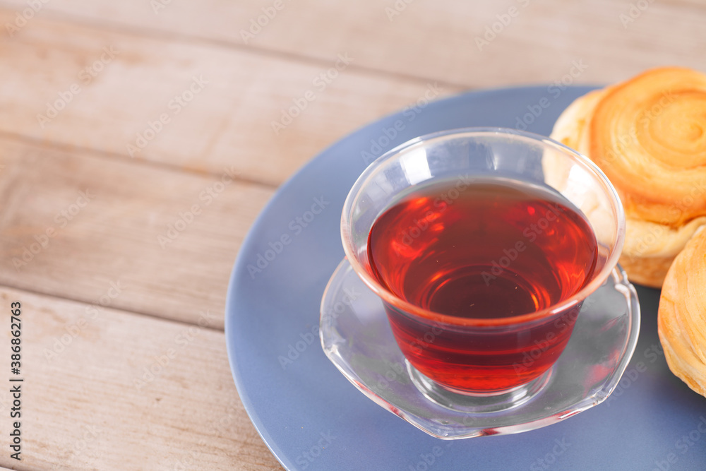 A bowl of black tea and refreshments A bowl of black tea and refreshments