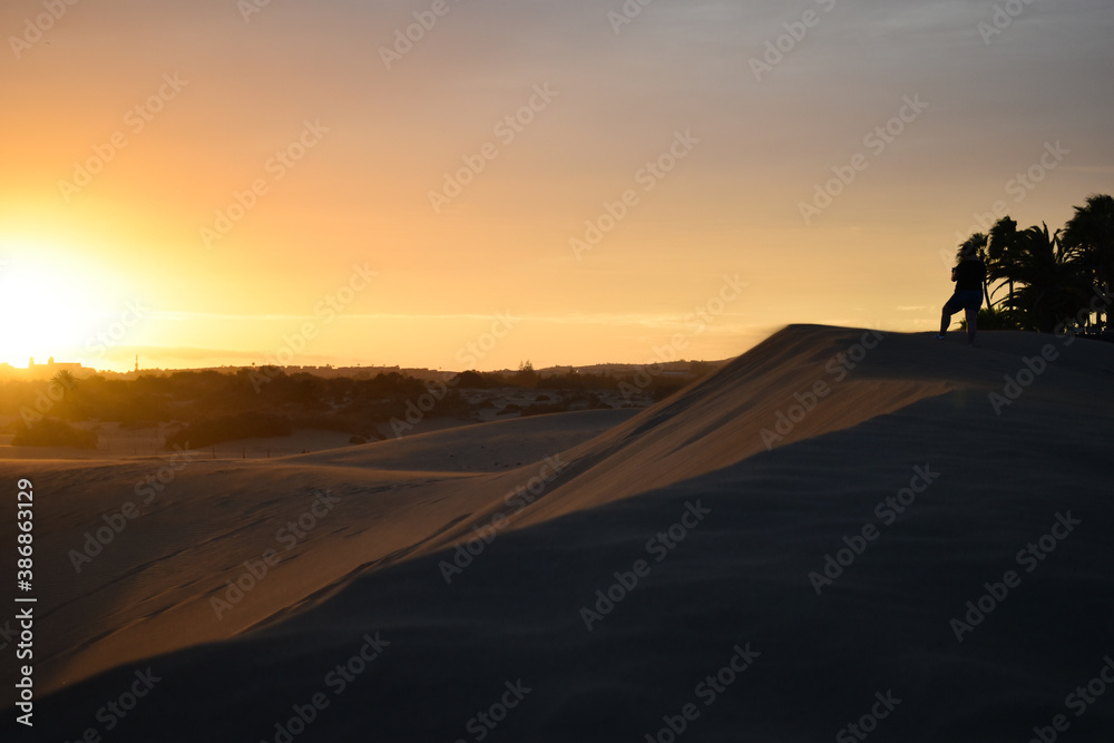 Violet and orange sunset in the sand dunes of Maspalomas, Gran Canaria.