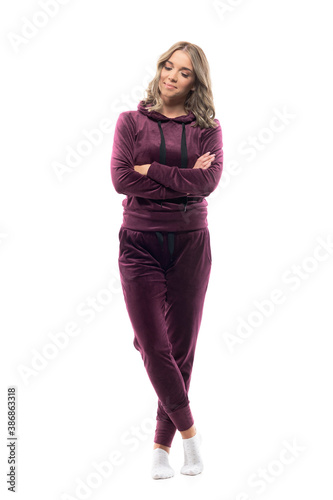 Relaxed happy young casual woman in cozy clothes wearing socks with crossed hands. Full body isolated on white background.