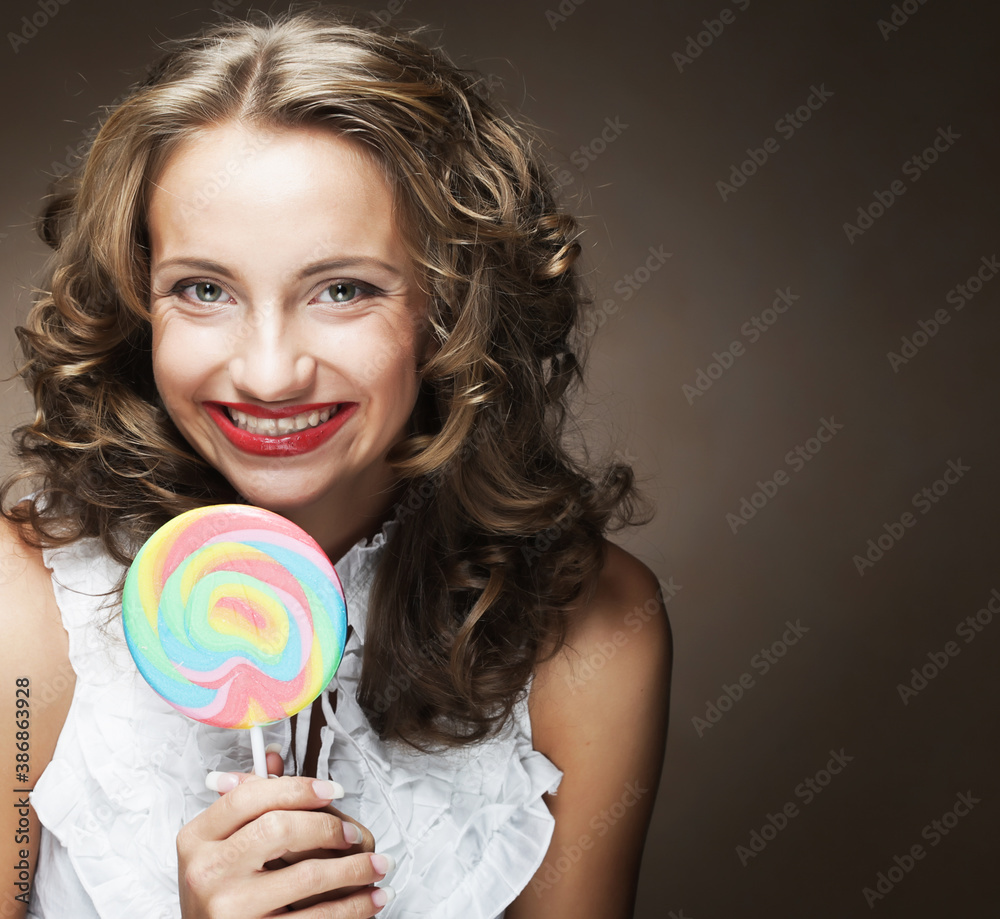 curly girl with a lollipop in her hand