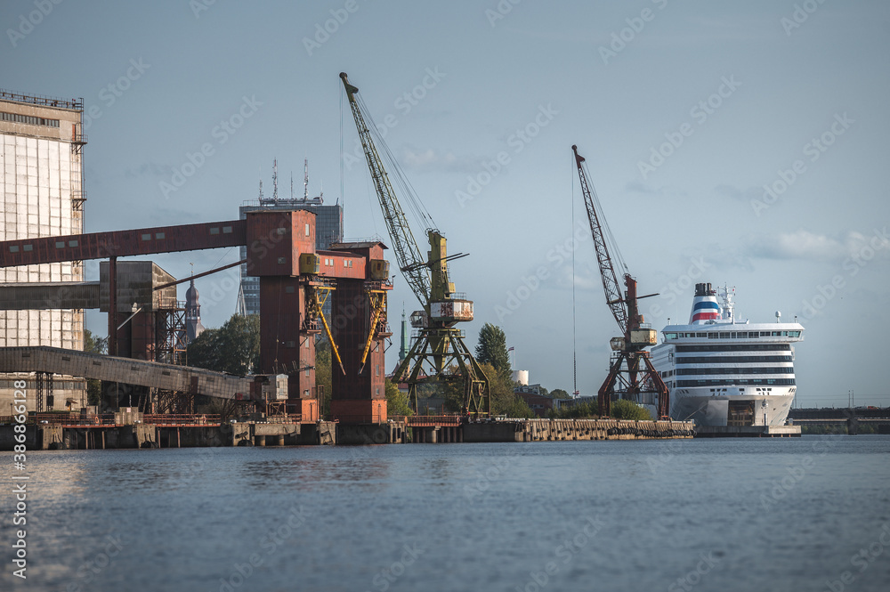 
Riga, Latvia 09.15.2020. Photoshoot of Riga terminal. Industrial environment, cargo ships, container cranes. Urban landscape. 
