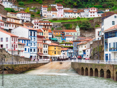 CUDILLERO, SPAIN - OCTOBER 19, 2019: Coastal town of Cudillero with terraced houses, fishing village and tourist destination photo