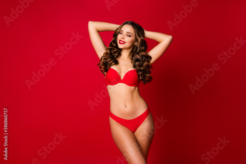 Photo of seductive perfect beautiful appearance lady slim body shapes hold arms behind head eyes closed wear brassiere panties underwear advertising model isolated vivid red color background