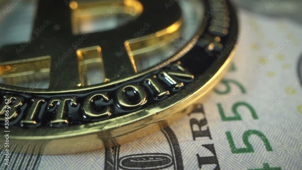 American Dollars and cryptocurrency Bitcoin on the table. Macro sign ig Bit coin with panorama. Gold crypto coin against powerful US banknote. Blockchain technology. Money of the future. Digital