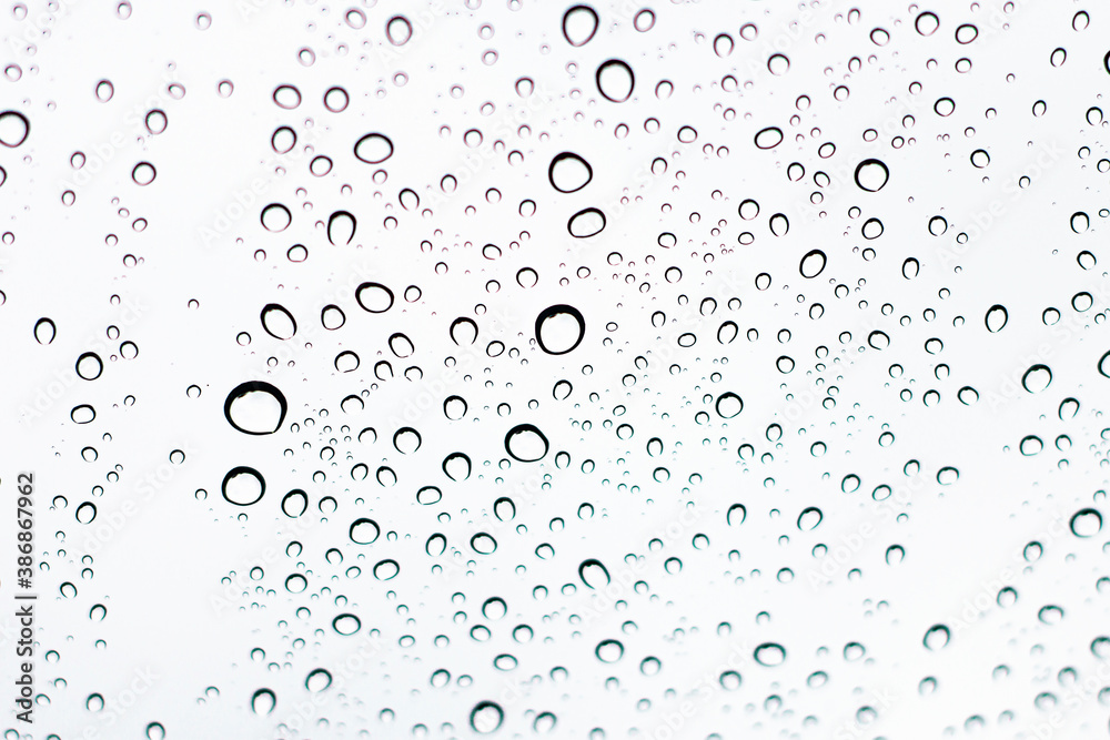 Water droplets adhering to the windshield of the car.