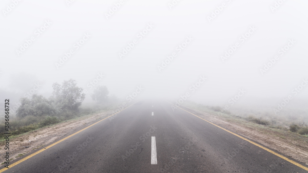 Empty highway road in fog