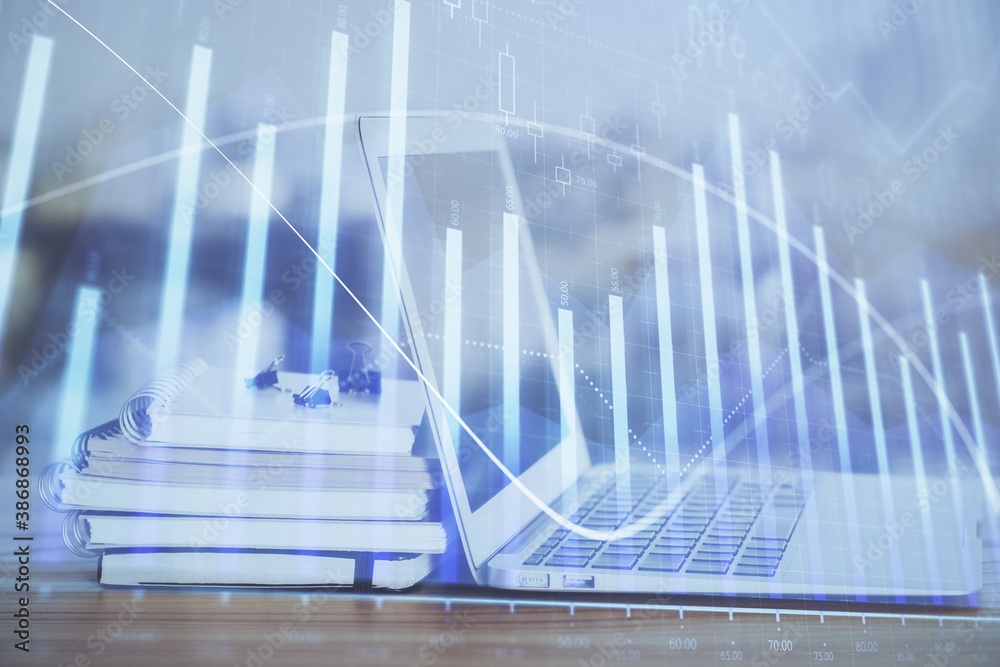 Forex graph hologram on table with computer background. Multi exposure. Concept of financial markets. Forex graph hologram on table with computer background. Multi exposure. Concept of financial markets.