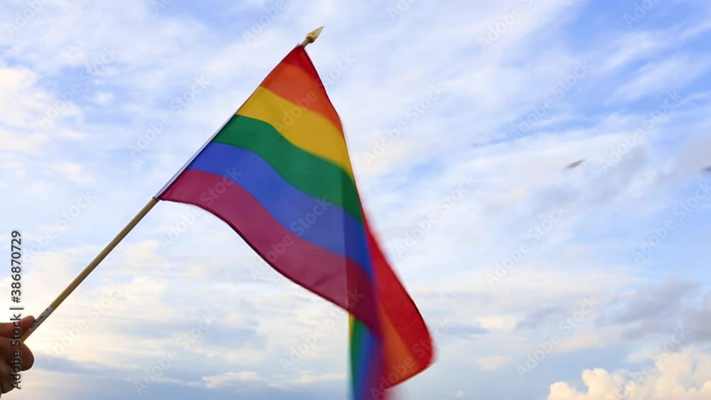 LGBT flag blown by the wind at seaside representing love and freedom. LGBT flag blown by the wind at seaside representing love and freedom.