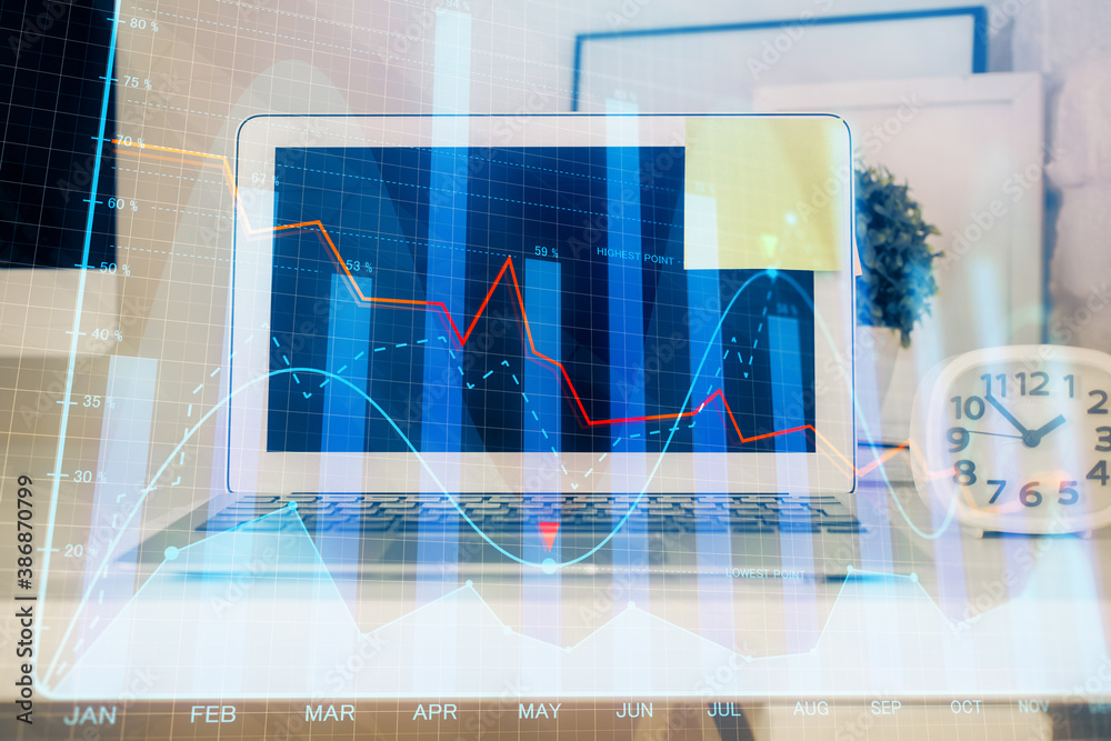 Financial market graph hologram and personal computer on background. Double exposure. Concept of forex. Financial market graph hologram and personal computer on background. Double exposure. Concept of forex.