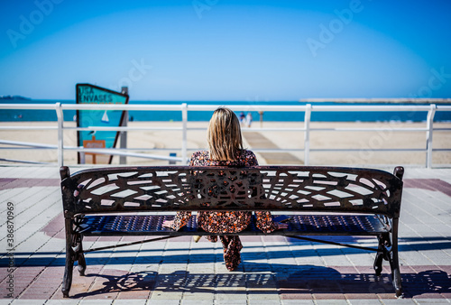 Woman enjoying the sun looking at the mediterranean sea in Valdelagrana, El Puerto de Santa Maria - Cádiz - Andalusia photo