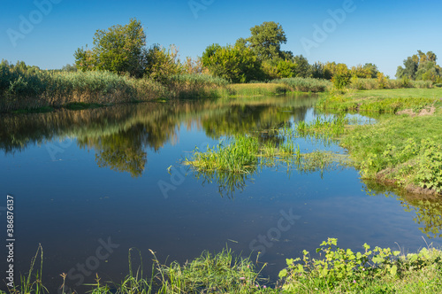 Tranquil summer landscape with small river Merla in Poltavskaya oblast, Ukraine