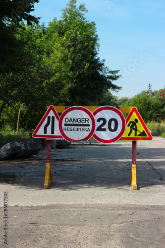 International traffic signs 'Left lane is merged', 'Danger', 'Maximum speed restriction', 'Road construction'.