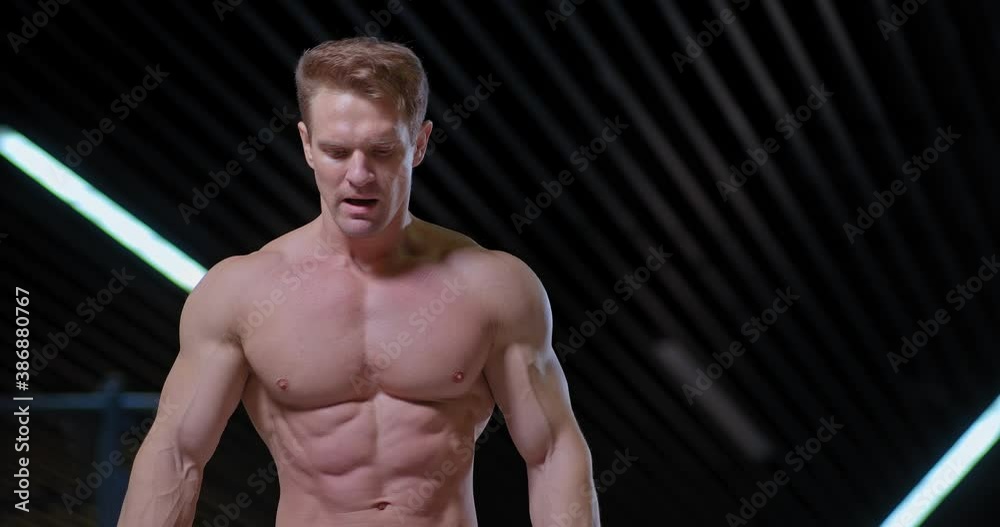 Portrait of a professional sportsman, pumped up torso and arms. End of the training, the male athlete is breathing heavily, his face is tense. 4k, ProRes Portrait of a professional sportsman, pumped up torso and arms. End of the training, the male athlete is breathing heavily, his face is tense. 4k, ProRes