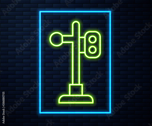 Glowing neon line Train traffic light icon isolated on brick wall background. Traffic lights for the railway to regulate the movement of trains. Vector.