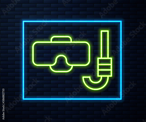 Glowing neon line Diving mask and snorkel icon isolated on brick wall background. Extreme sport. Diving underwater equipment. Vector.