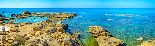 The sharp rocks on the shore of Caesarea, Israel photo