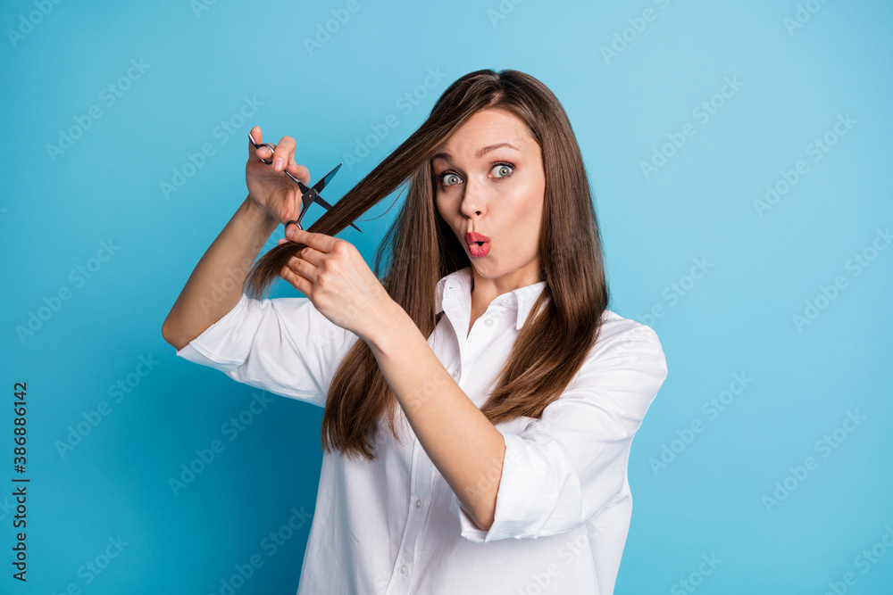 Photo of crazy hairdresser lady hold scissors cut down split ends decision wear white shirt isolated blue color background Photo of crazy hairdresser lady hold scissors cut down split ends decision wear white shirt isolated blue color background
