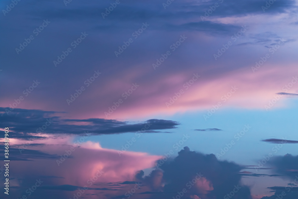 Pink and blue sky with clouds like cotton candy for peaceful background or wallpaper