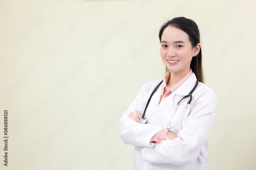 Asian female doctor stands and cross arms in office at hospital. Asian female doctor stands and cross arms in office at hospital.