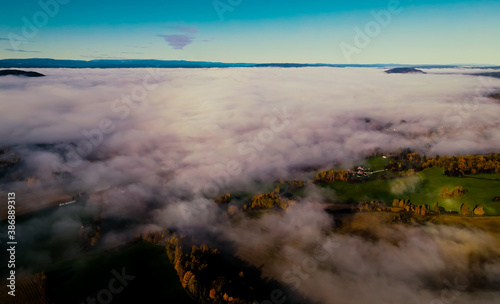 Heavy fog in a valley during sunrise.