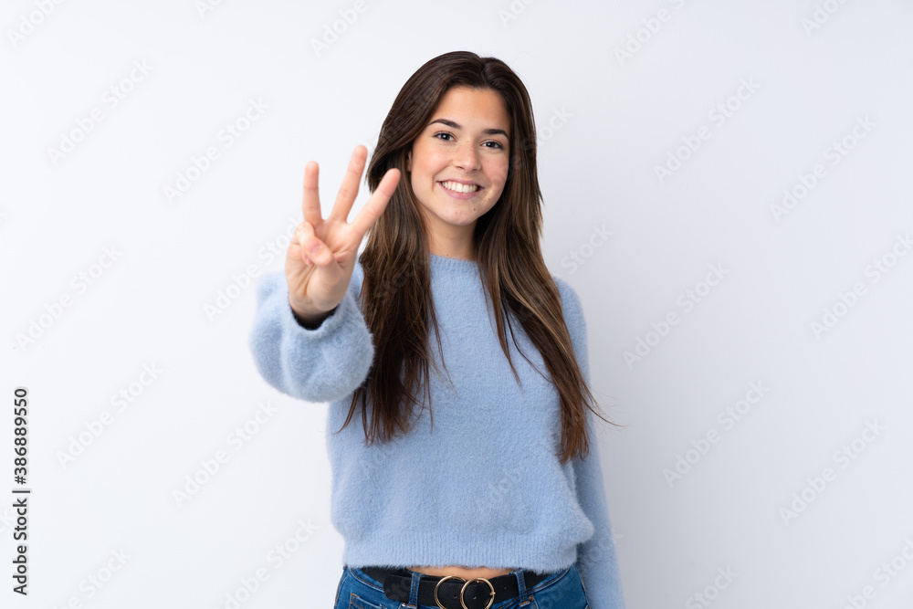Teenager girl over isolated white background happy and counting three with fingers