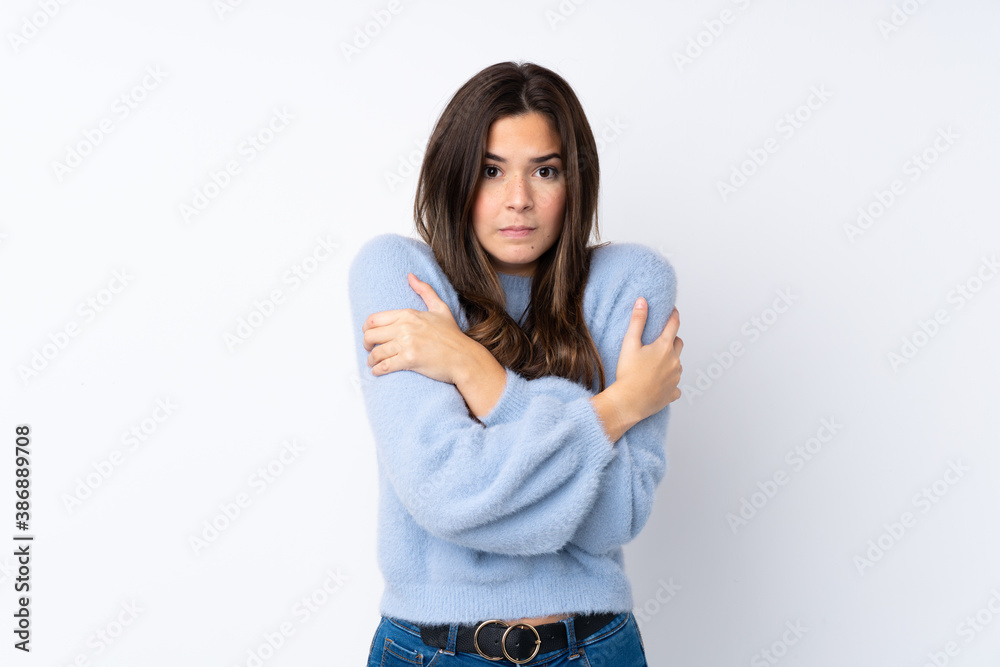 Teenager girl over isolated white background freezing Teenager girl over isolated white background freezing