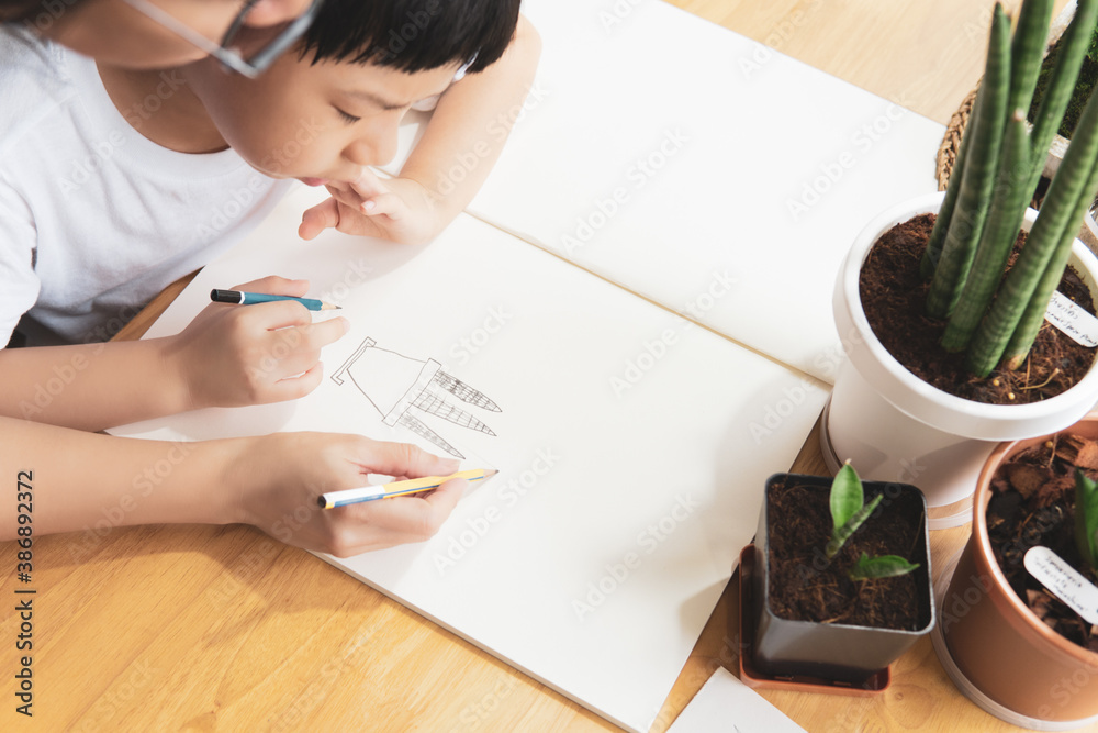 Top view close up of an asian mom teaching her adorable little boy how ...