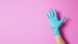 right hand wear surgical glove doing five finger on pink background.