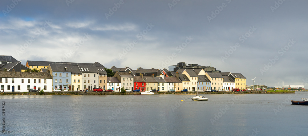 Panoramic view of colored houses in Galway Bay on a cloudy day.