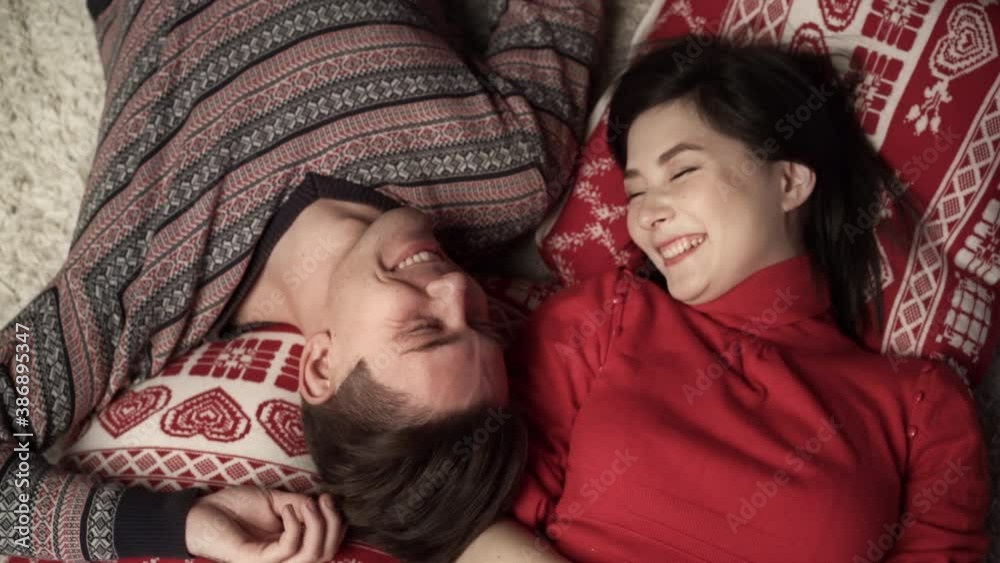 Happy couple enjoying xmas and lying head to head. Top view. Relationship, family, christmas, new year, holiday concet.
