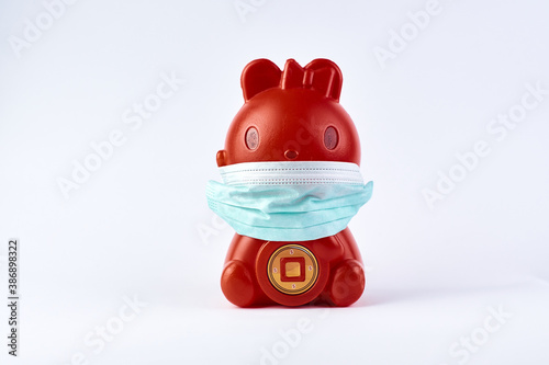 Health, safety and pandemic concept, Red Piggy bank wear medical mask for pretection from virus disease  photo