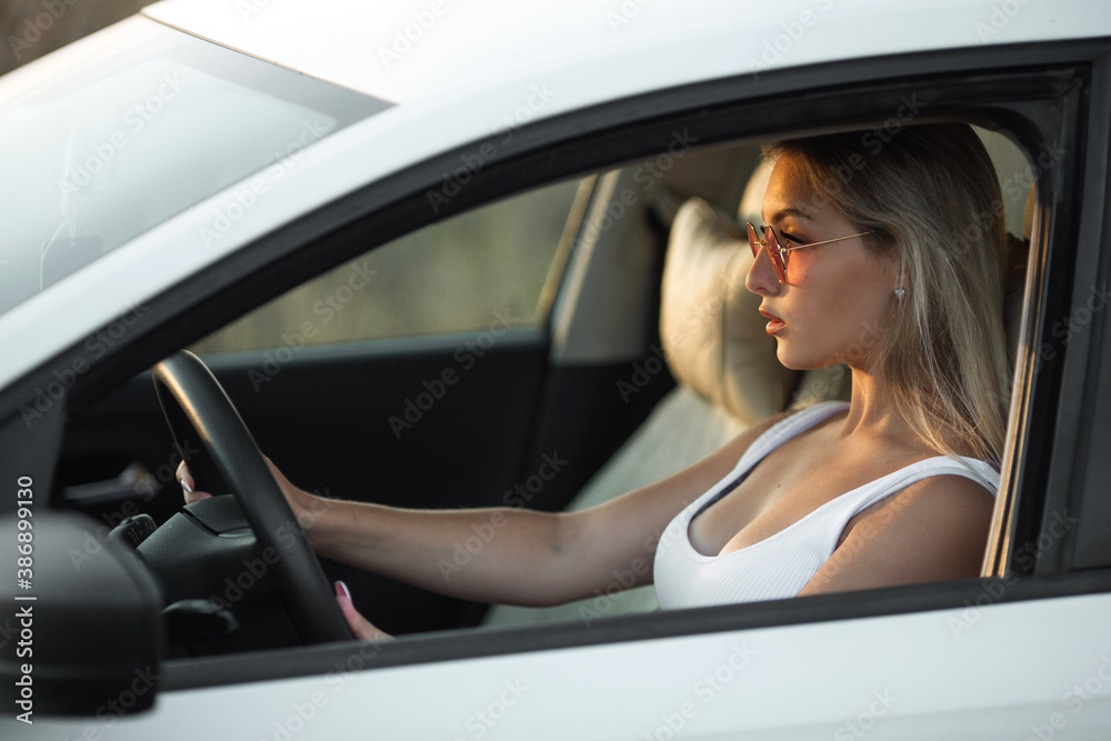 beautiful young female driving a car