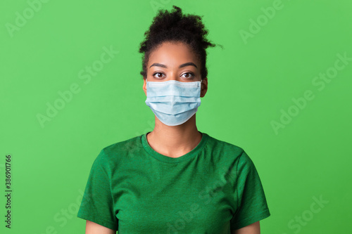 Portrait of black young woman in medical mask © Prostock-studio
