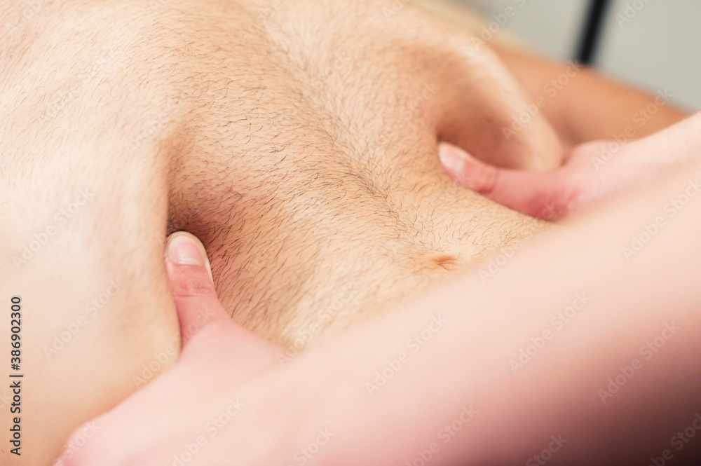 Professional massage and placement of the diaphragm and internal organs of the abdominal cavity. Close-up Professional massage and placement of the diaphragm and internal organs of the abdominal cavity. Close-up