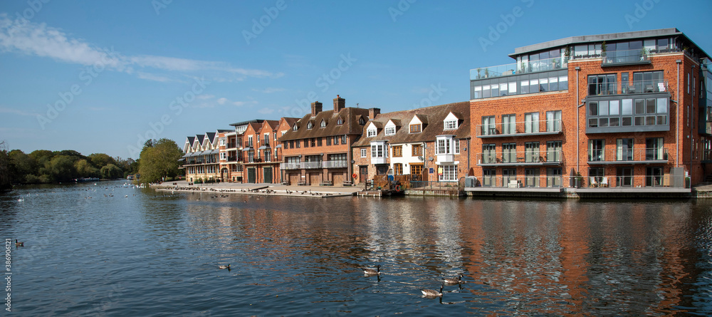 UK. 2020. Modern properties line the waterfront overlooking a river