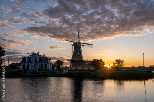 Sunset at Rotterdam's Kralingse Plas, the typical Dutch windmill in the background