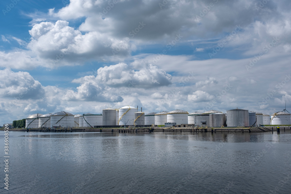 Fototapeta premium Port of Rotterdam. Botlek. Oil refinery plant from industry zone, oil and gas industrial, Refinery factory oil storage tank and pipeline steel