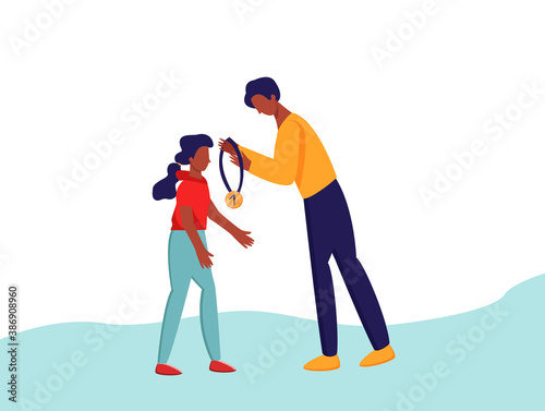 A man awards a girl a medal, hang the medal around her neck. The process of awarding the medal