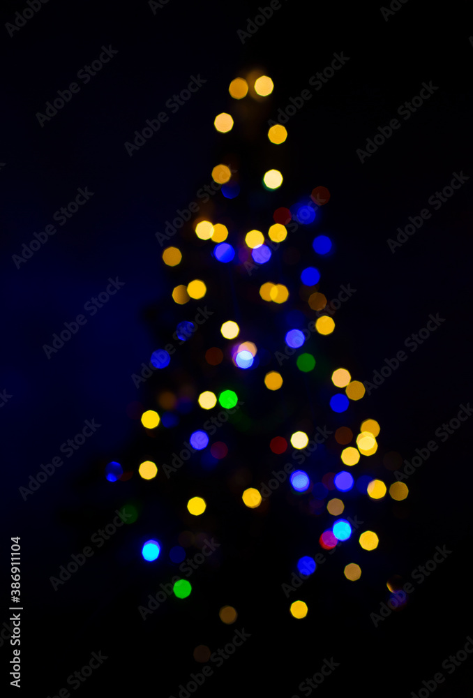 christmas tree blurred in bokeh of various colors christmas tree blurred in bokeh of various colors