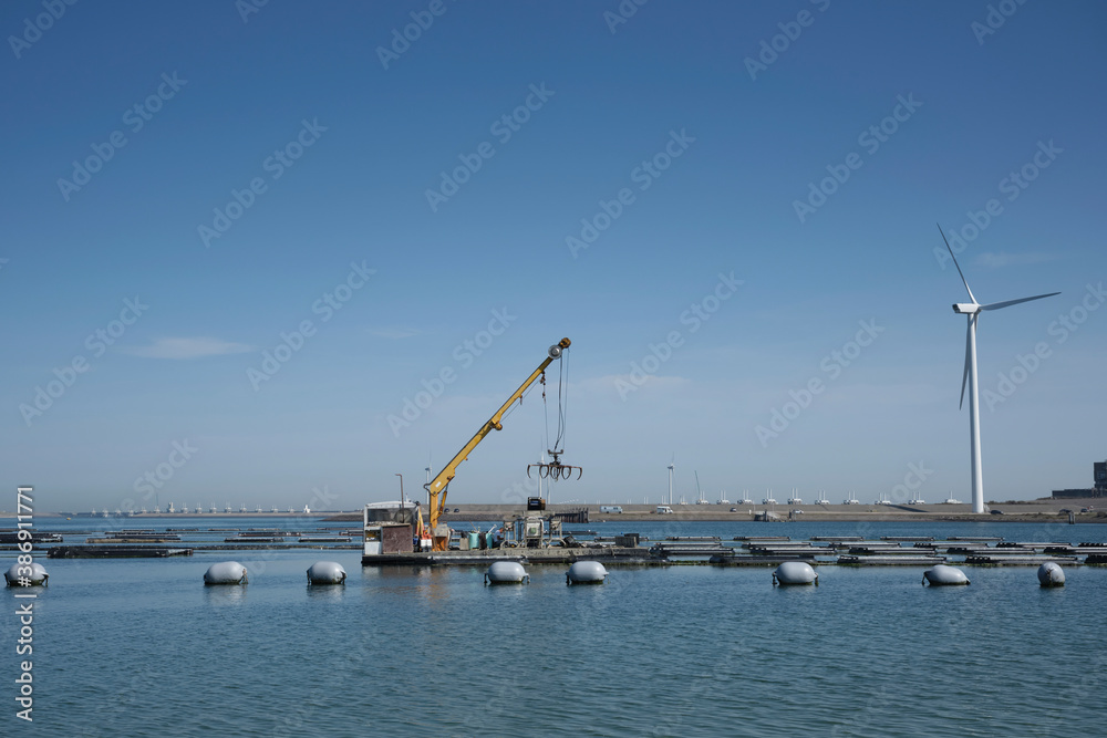 Large mussel farm is in the foreground fot the Storm surge barrier in Zeeland, Holland