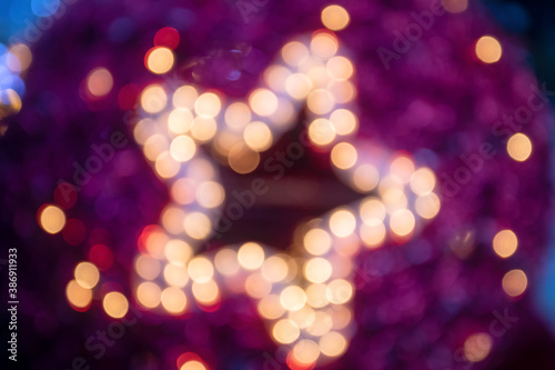 Christmas ball with shiny star and defocused lights