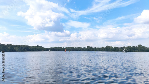 Several sailboats on a beautiful blue lake. © Natasha 