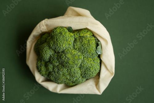 Broccoli in a reusable cotton mesh shopping bag. Zero waste concept. Eco-friendly lifestyle. Zero waste, healthy, vegan and clean eating concept. Plastic free items. Reuse, reduce, recycle, refuse.