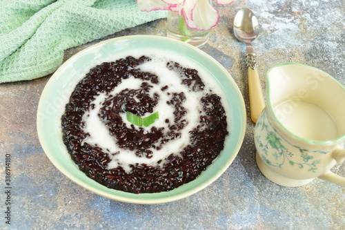 Indonesian traditional dessert: Bubur Ketan Hitam or black glutinous rice porridge with coconut milk sauce. Ramadan menu