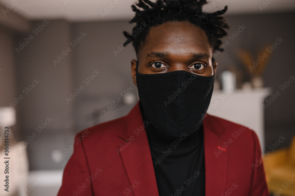 portrait of an afro american in a suit wears a black medical mask portrait of an afro american in a suit wears a black medical mask