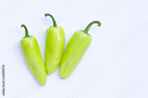 Geen hot peppers on a white background.