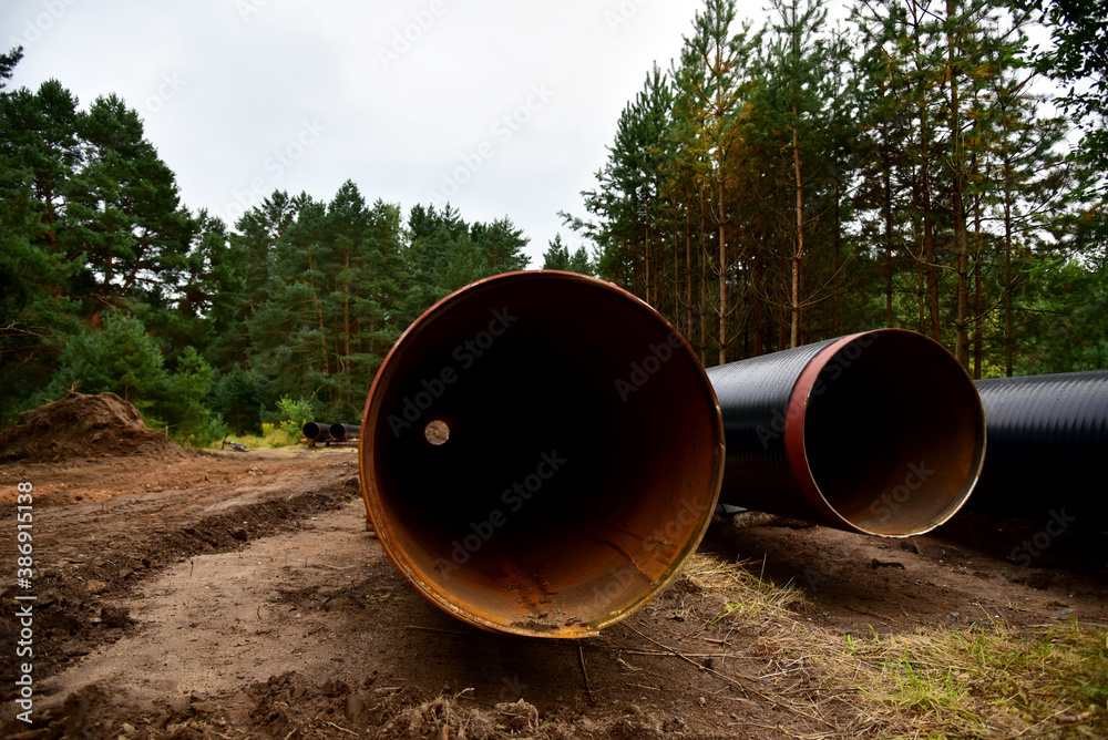 Natural gas pipeline construction work in forest area. Installation of gas and crude oil pipes. Construction of gas pipes to new LNG plant. Natural gas pipeline construction work in forest area. Installation of gas and crude oil pipes. Construction of gas pipes to new LNG plant.